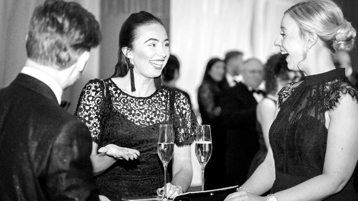 Guests reacting to close-up magic performed by James Pritchard at a corporate event